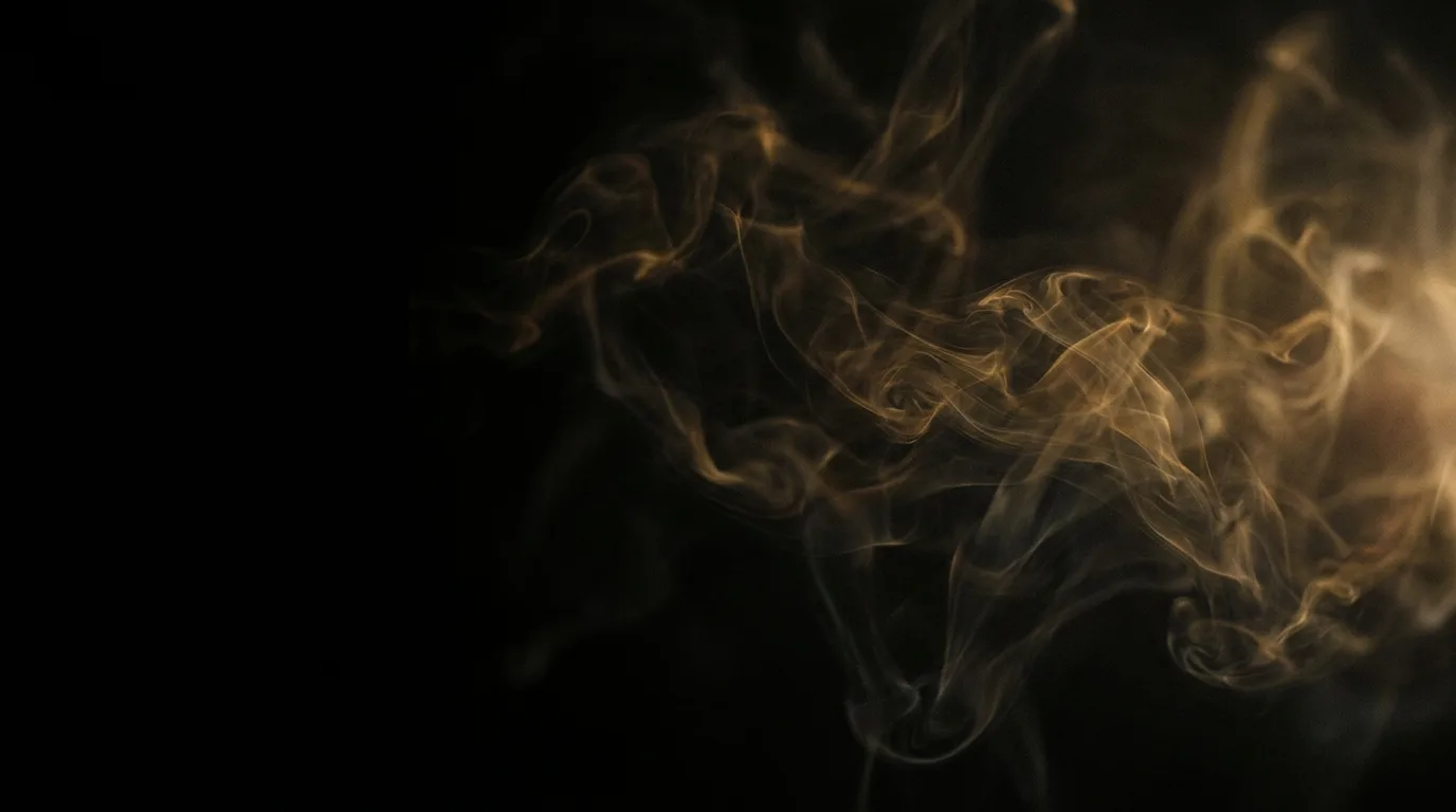 Warm amber smoke wisps curling across solid black with open space on the left.